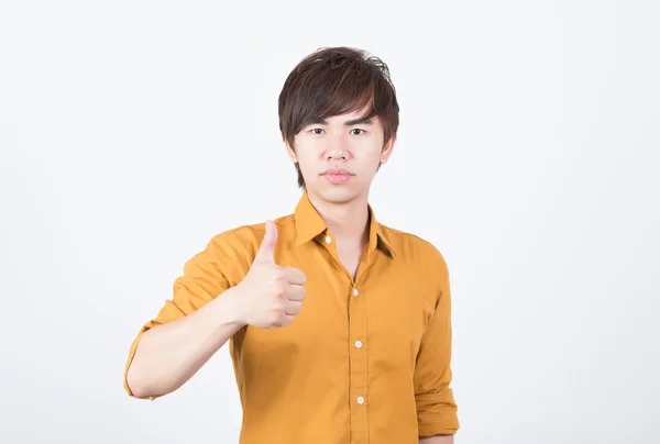 Handsome man in orange shirt thumb up — Stock Photo, Image