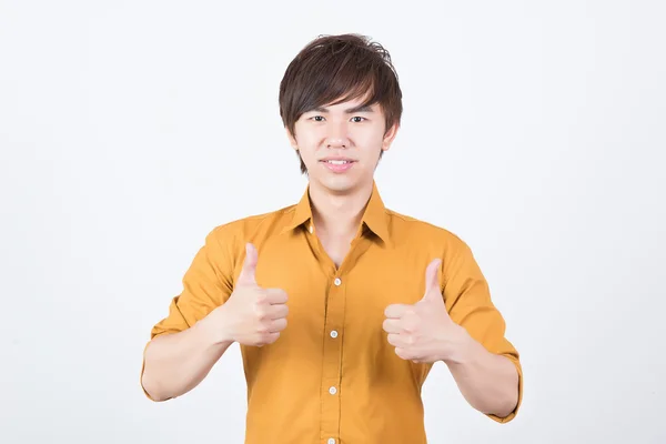 Handsome man in orange shirt thumb up — Stock Photo, Image