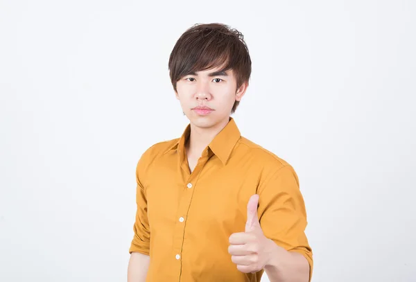 Handsome man in orange shirt thumb up — Stock Photo, Image