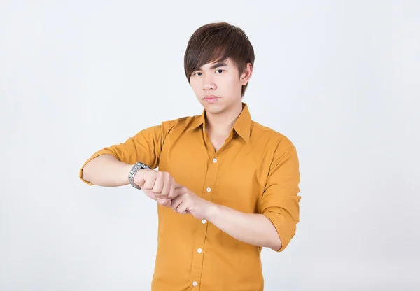 Handsome  man in orange shirt checking time — Stock Photo, Image