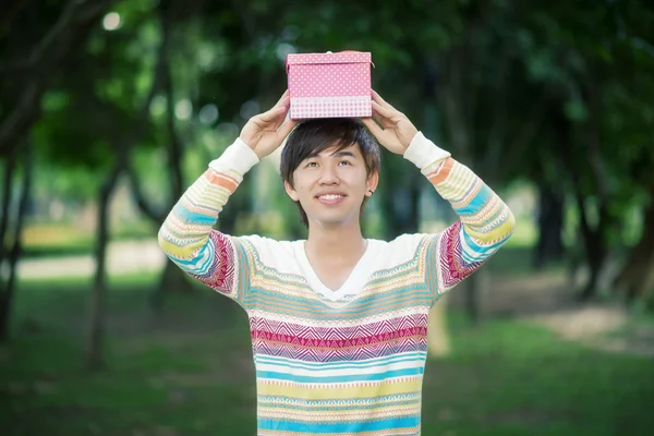 Male is holding a pink gift box — Stock Photo, Image