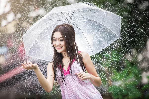 Mooi meisje in de regen met transparante paraplu — Stockfoto