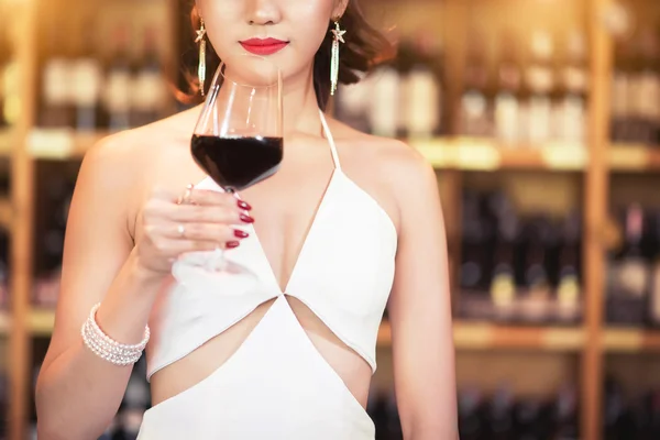 Beautiful asian woman with a glass of wine — Stock Photo, Image