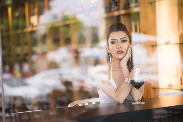 Beautiful asian woman with a glass of wine — Stock Photo, Image