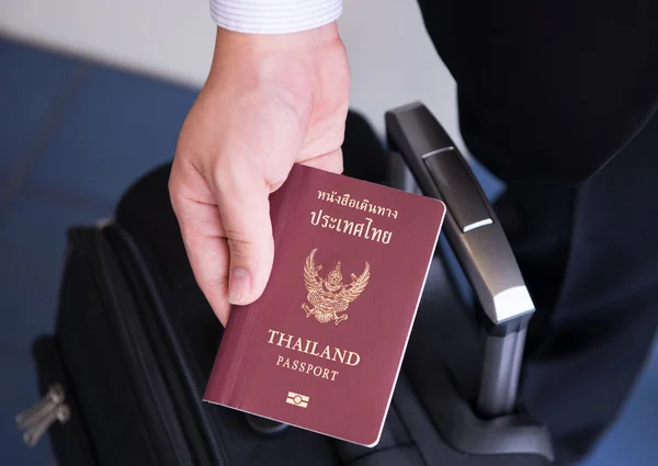 Hand holding Thai passport, ready to travel — Stock Photo, Image