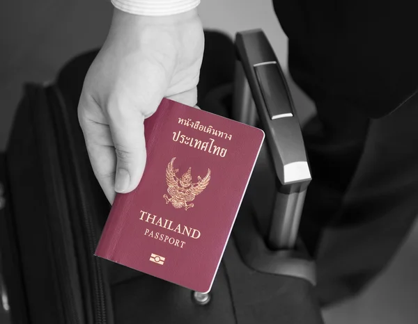 Hand holding Thai passport, ready to travel — Stock Photo, Image