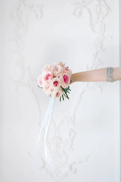 Krásná klasická svatební kytice v rukou nevěsty. růžové pivoňkové růže. — Stock fotografie