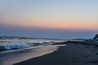 Kumsalda gün batımının fotoğrafı
