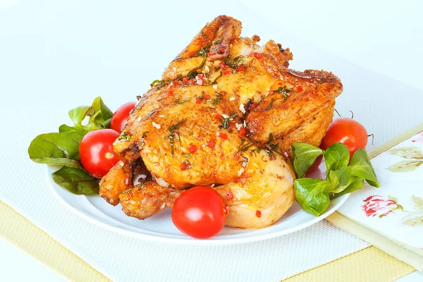 roasted chicken  with tomatoes and herbs on a plate
