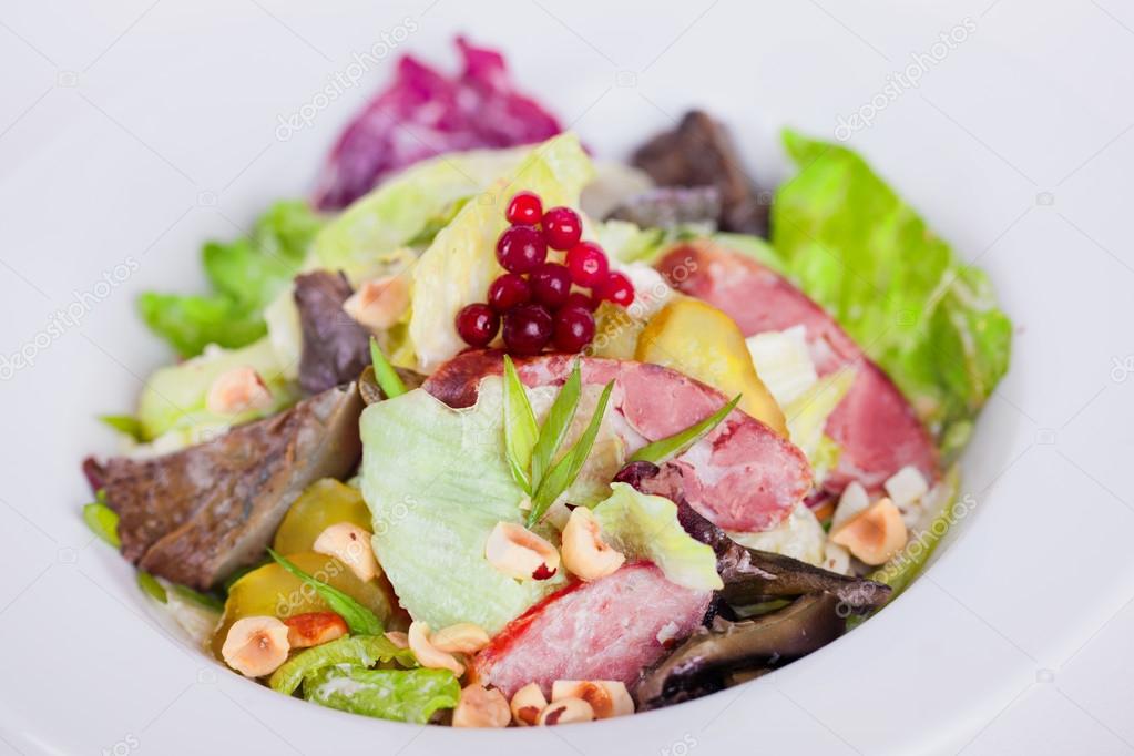 food, salad with iceberg, meat, mushrooms, pickles and hazelnuts piquant