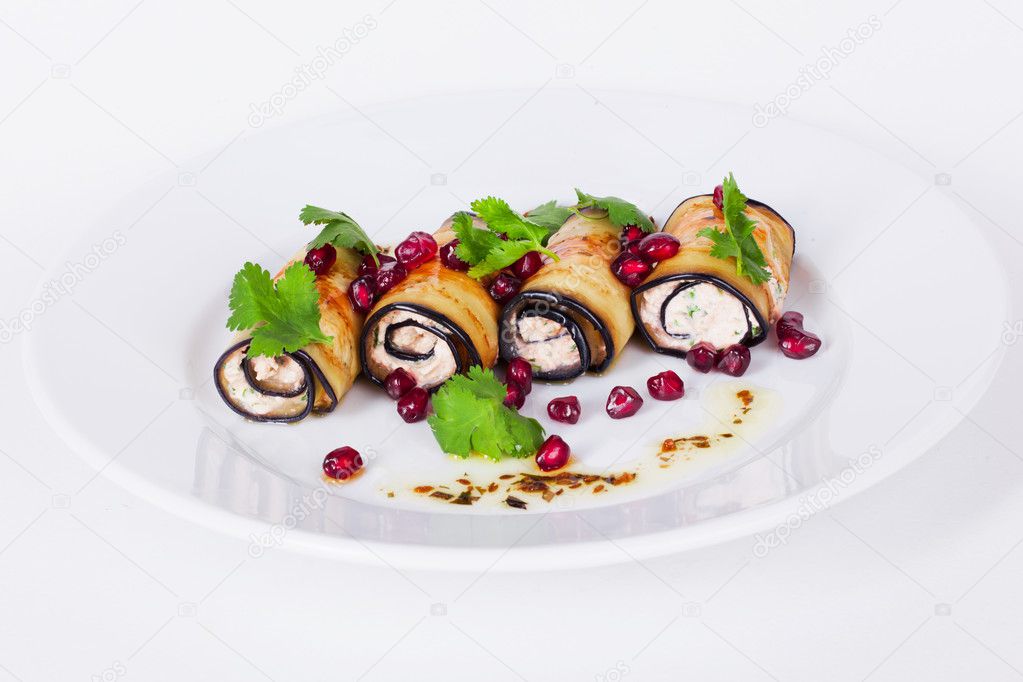 rolls of eggplant with pomegranate seeds and paste isolated on white background