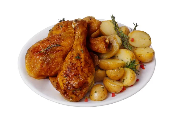 Fried chicken legs with potatoes, rosemary and thyme spices isolated on a white background — Stock Photo, Image