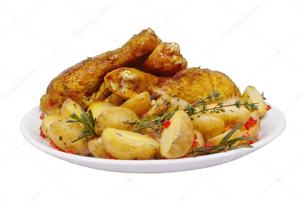 Fried chicken legs with potatoes, rosemary and thyme spices isolated on a white background 