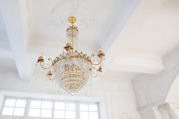 Chandelier in the interior of white gold with glass pendants — Stock Photo, Image