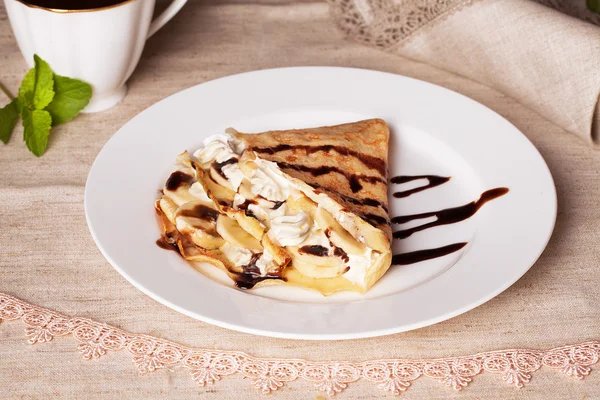 Pancake with banana and whipped cream in a still life rural rustic, flax — Stock Photo, Image