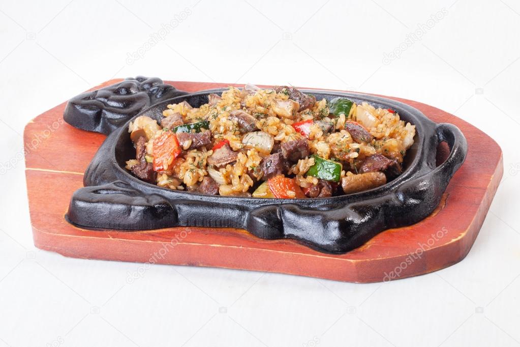 beef with meat and vegetables in the form of iron cow isolated on a white background top