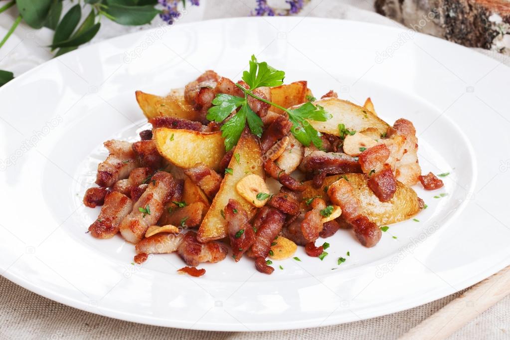potato wedges with bacon on a plate