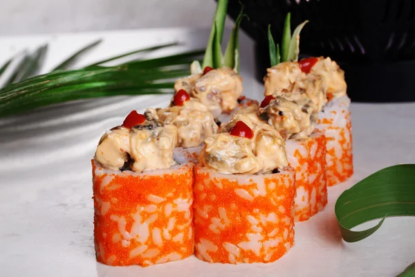 Sushi-Rolle heiß, appetitlich, groß, Lachs, Orange, Sauce, Kimchi, Sesam, geräuchert, Gurke, tropisch, Blattpalme — Stockfoto