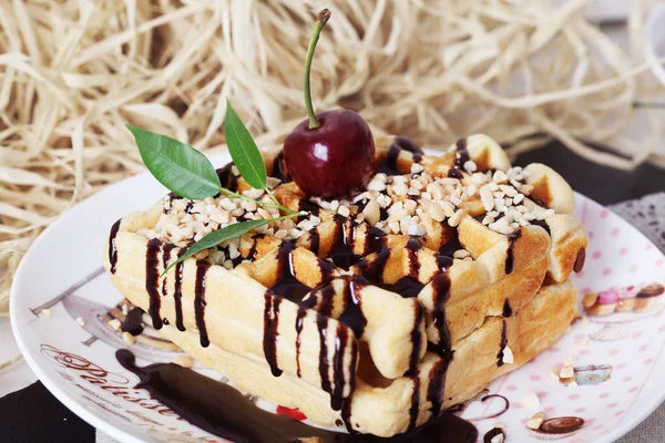 Belgian waffles with peanut chocolate sauce and cherries on a plate — Stock Photo, Image