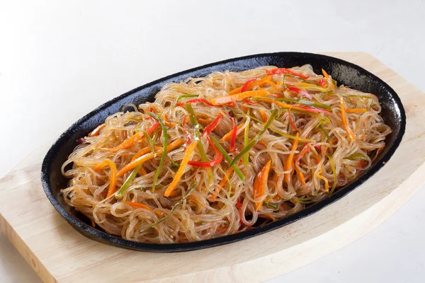 Crystal noodles with vegetables in a pan isolated cast iron wok — Stock Photo, Image