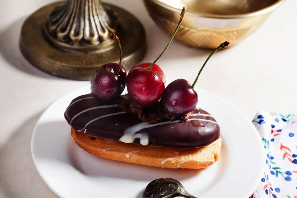 Shortbread cake with chocolate eclair a cherry — Stock Photo, Image