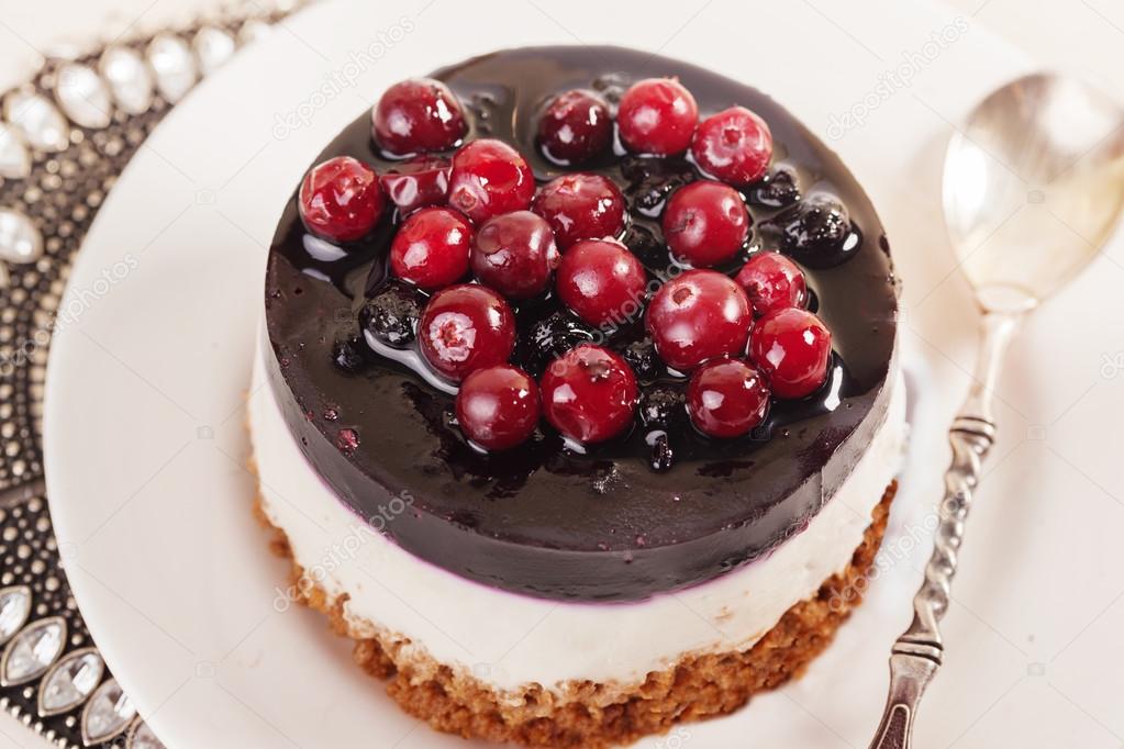 cake with cranberry jelly cream round shape berries closeup