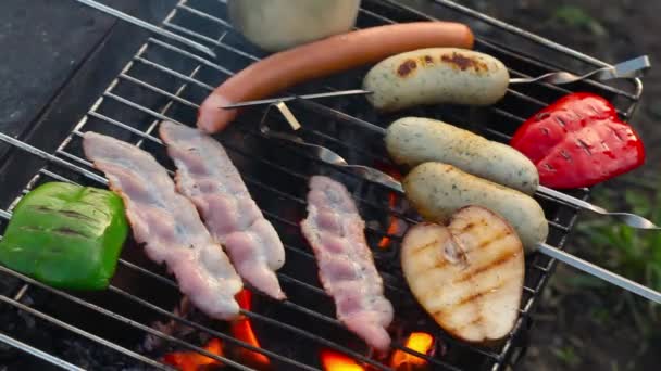 Bacon and sausages fried on a grill fire flame grill rosemary — Stock Video