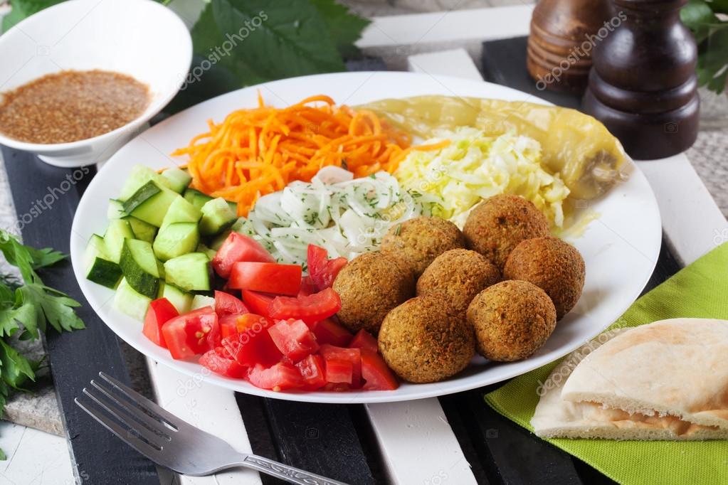 falafel plate on top to garnish, carrot, cabbage, onion, cucumbers, tomatoes, still life, dish