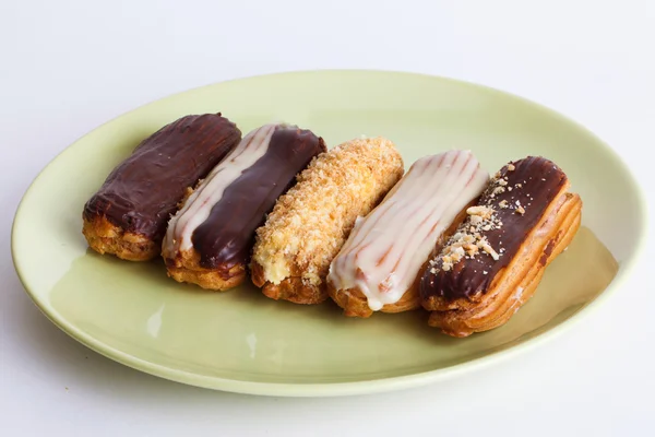 Eclairs different species on a plate — Stock Photo, Image