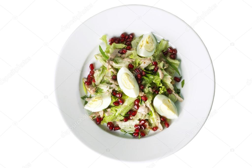 chicken salad and pomegranate on a plate