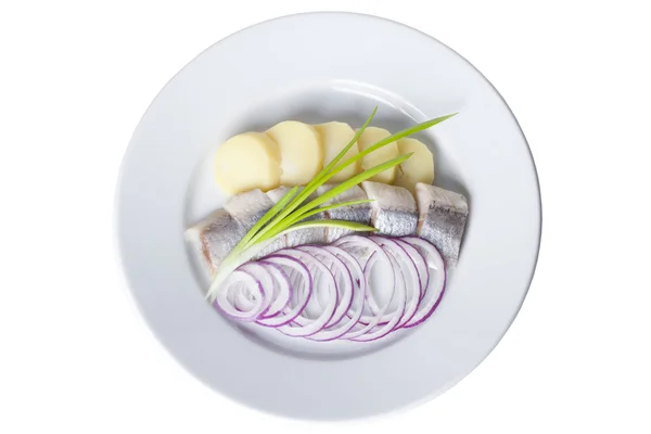 Pieces of herring with potatoes, red onions on a plate — Stock Photo, Image