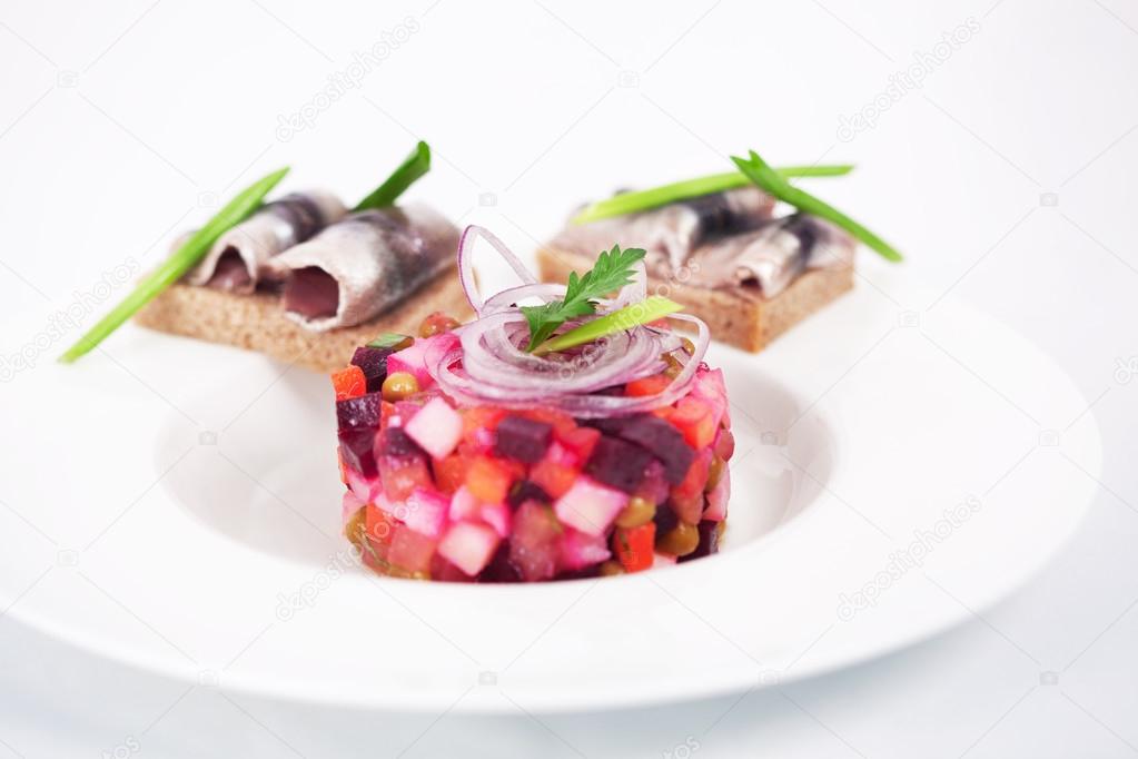 salad and sandwiches with herring