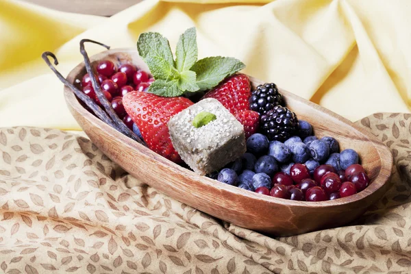 Bowl with berries and mint candy — Stock Photo, Image