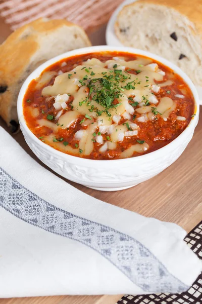 Hot tomato soup with onions spoon — Stock Image Hot tomato soup with onions spoon Stock Image