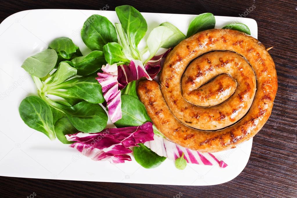 Grilled sausages snail with easy side dish of corn salad, red cabbage