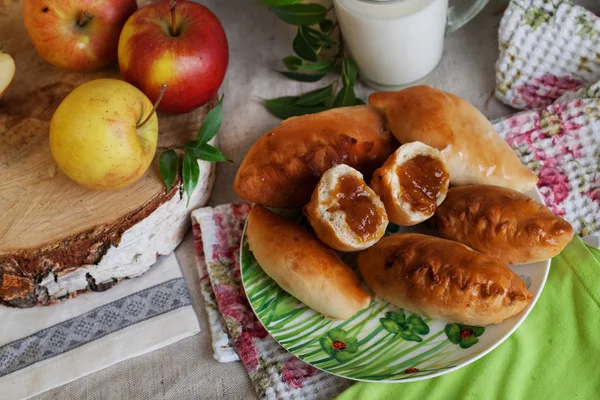 Rustic still life with pies, apple jam and milk — Stock Photo, Image