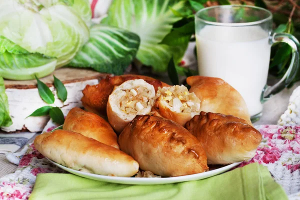 Rustic still life with pies, cabbage and milk — Stock Photo, Image