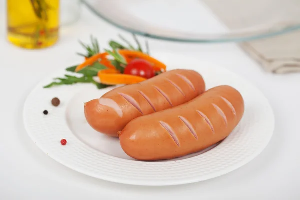 Sausages with vegetables on a plate — Stock Photo, Image