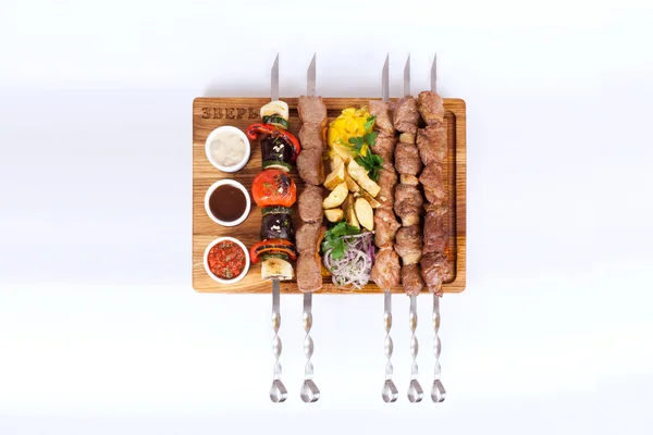 Assorted kebabs on a board white background, food, barbecue — Stock Image Assorted kebabs on a board white background, food, barbecue Stock Image