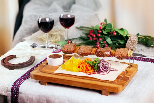 Meat skewers wooden board still life in a Christmas New Year holiday meal wine — Stock Photo, Image