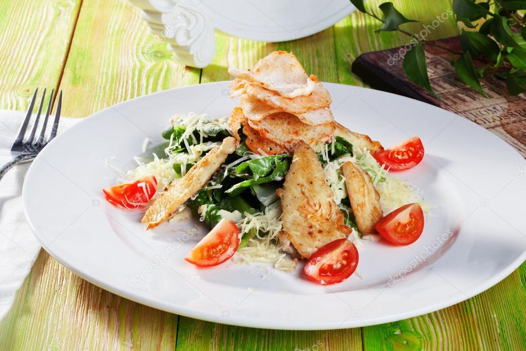 Caesar salad in a still life with chicken and croutons close-up for the menu