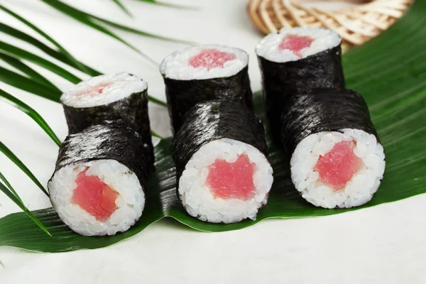 Sushi roll tuna chives mini kappa maki in the still life on a tropical leaves hosomaki — Stok Foto
