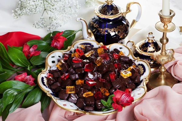Beautiful jelly candies in chocolate on a porcelain dish provence palace utensils still life, luxury, beauty, love, dating, food — Stock Photo, Image