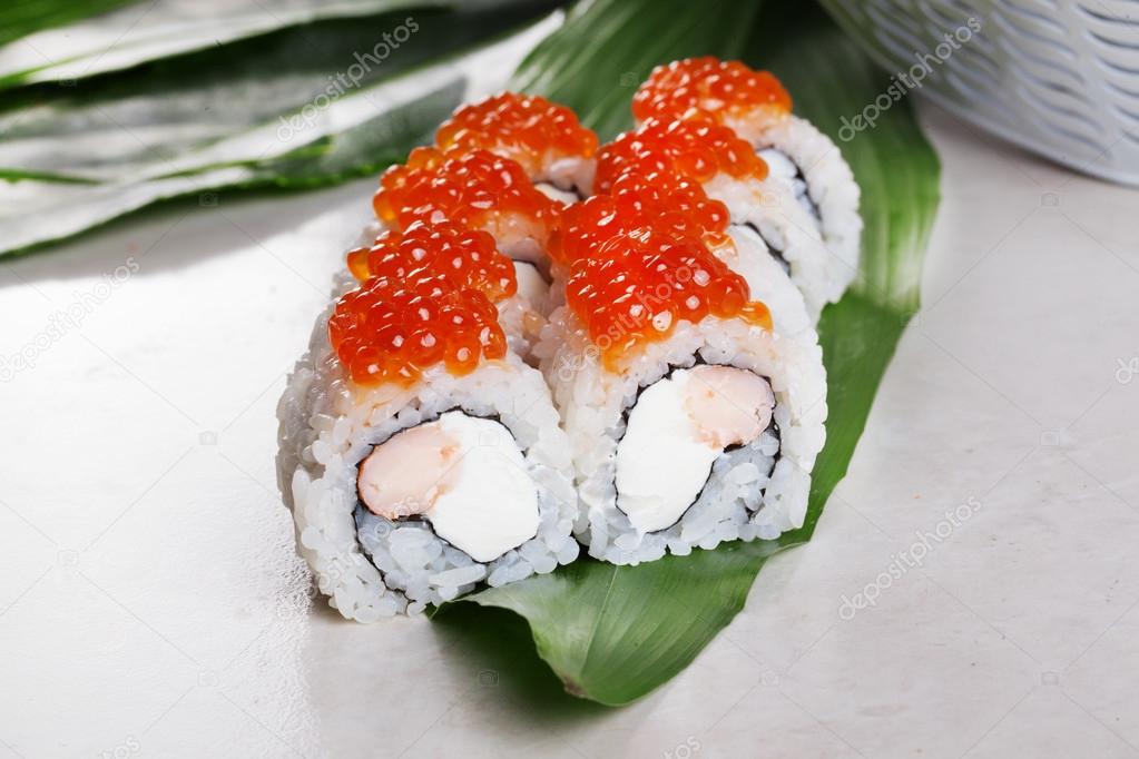 Philadelphia shrimp Roll Sushi Red caviar tropical leaves still life white boards for the restaurant menu