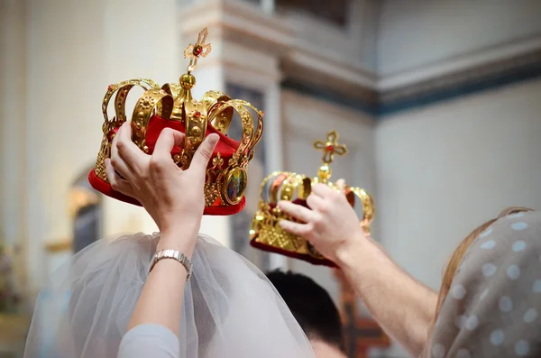 Sacral details of wedding ceremony -  bridal crowns above head — Stock Photo, Image