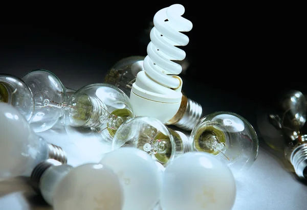 Bright light bulb on the desk — Stock Photo, Image
