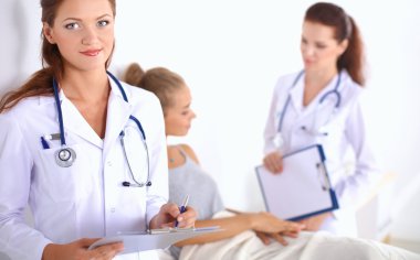 Hastanede üniformalı, gülümseyen bir kadın doktor.