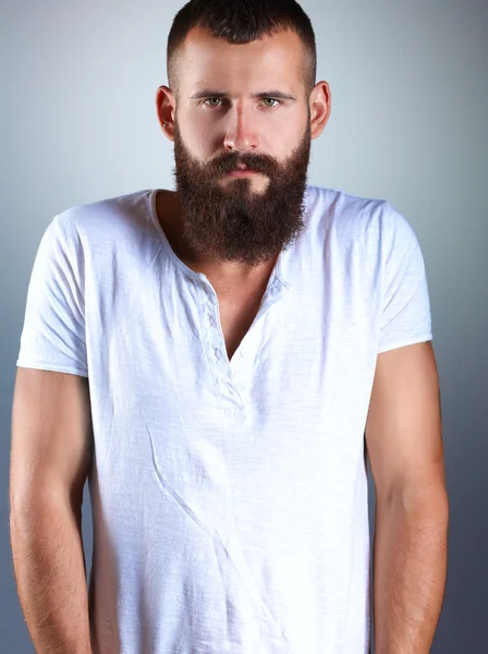 Portrait of handsome man standing, isolated on grey background — Stock Photo, Image