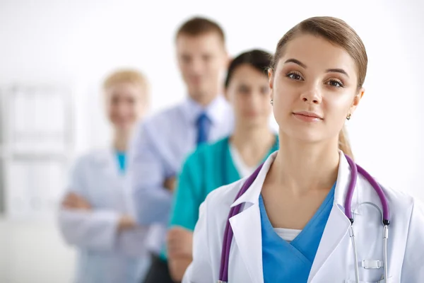 Attractive female doctor in front of medical group — Stock Photo, Image