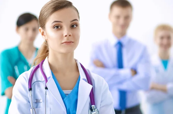 Attractive female doctor in front of medical group — Stock Photo, Image